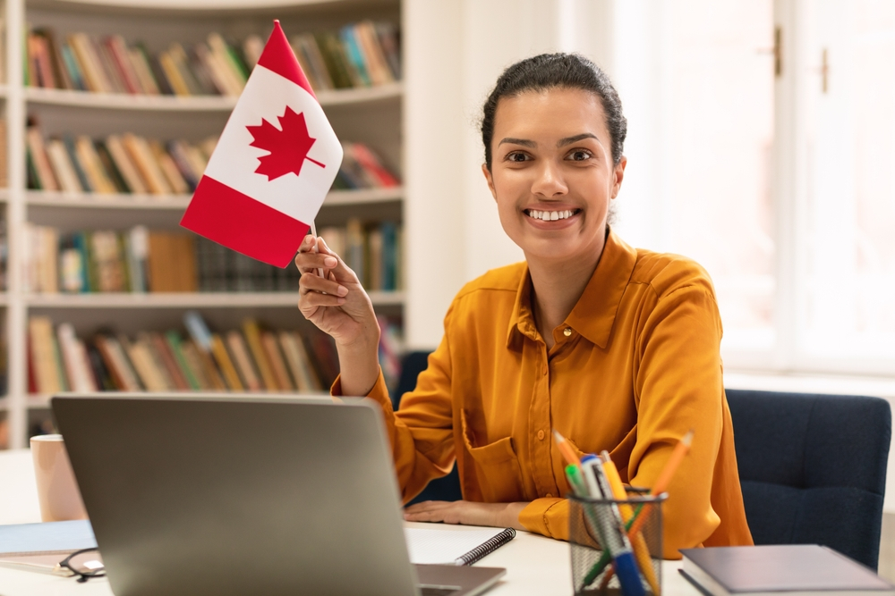 Remote Job Opportunities for Immigrants in Canada: Happy Mixed Race Woman Holding Flag.
