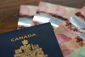 Canada visa for people living in Saudi Arabia: Image of a Canadian passport - cash isolated closeup