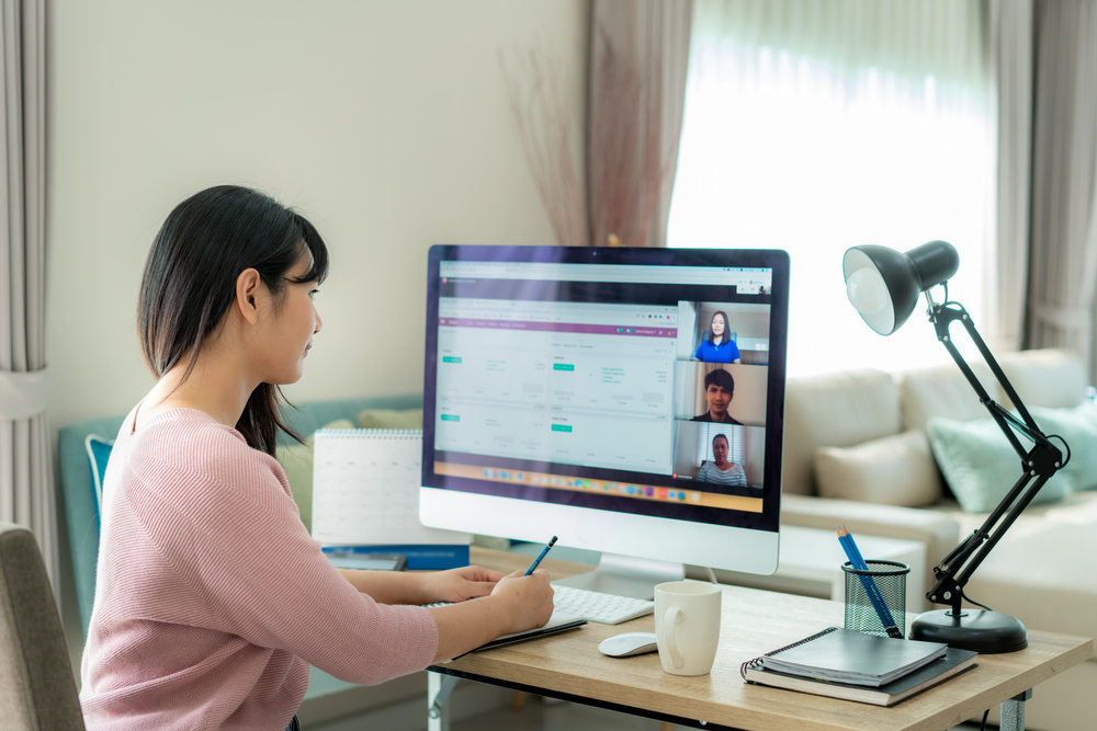 The Best and Worst Aspects of Remote Work: A career woman discussing with her colleagues in a video conferencing